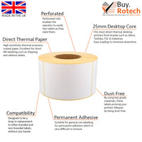 Single roll of white direct thermal labels with yellow backing paper, sitting upright on a white surface, labelled with descriptive features