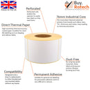Single roll of white direct thermal labels with yellow backing paper, sitting upright on a white surface, labelled with descriptive features